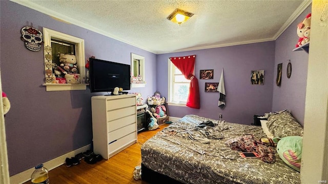 bedroom with crown molding, light hardwood / wood-style floors, and a textured ceiling