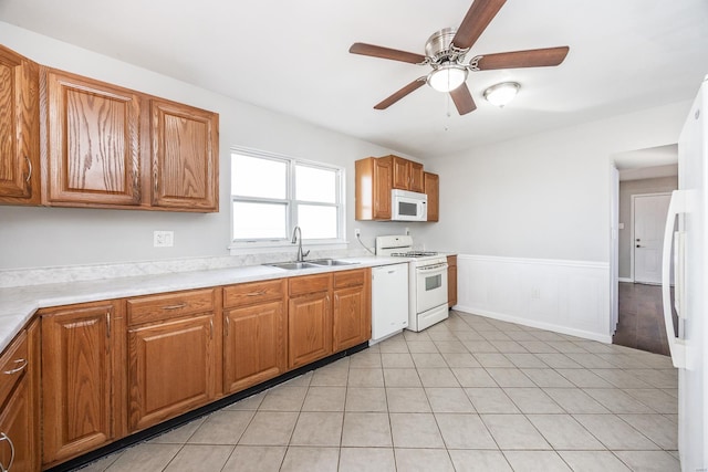 kitchen with sink, white appliances, and ceiling fan