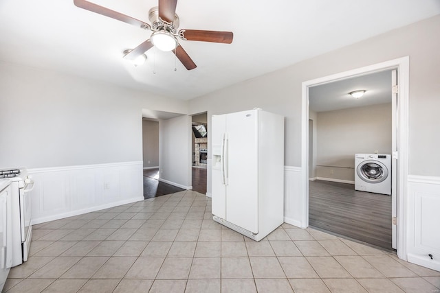 kitchen with light tile patterned floors, white appliances, ceiling fan, white cabinets, and washer / clothes dryer