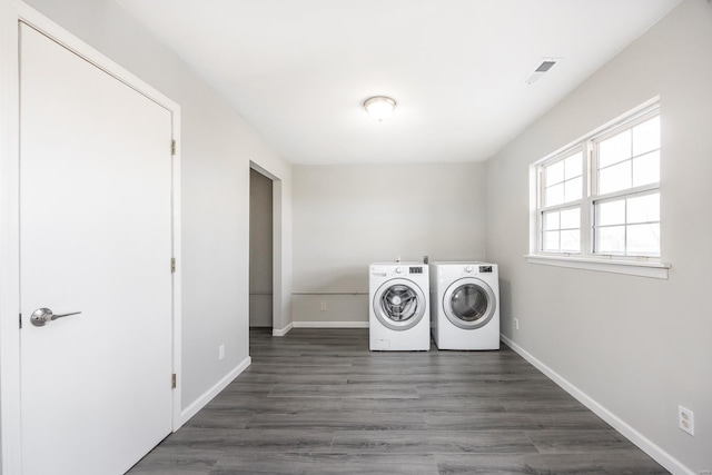 laundry area with dark wood-type flooring and washing machine and dryer