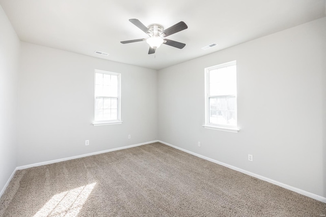 carpeted spare room with ceiling fan