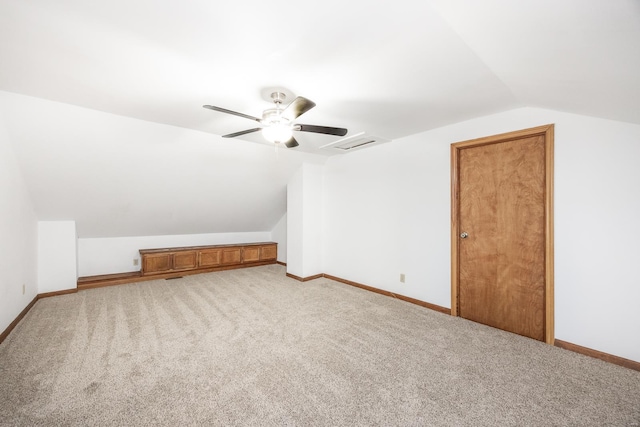 bonus room featuring vaulted ceiling, light carpet, and ceiling fan