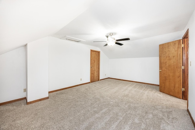 bonus room with ceiling fan, light colored carpet, and vaulted ceiling