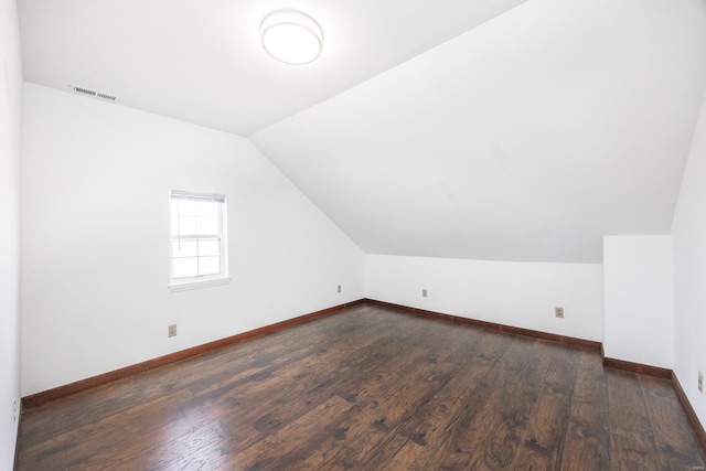 bonus room featuring vaulted ceiling and dark hardwood / wood-style floors