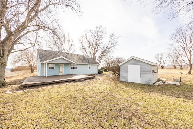 back of house featuring a storage shed, a yard, and a deck