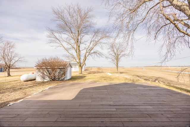 wooden terrace featuring a rural view