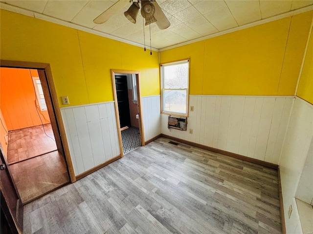 unfurnished bedroom featuring crown molding, ceiling fan, and wood-type flooring