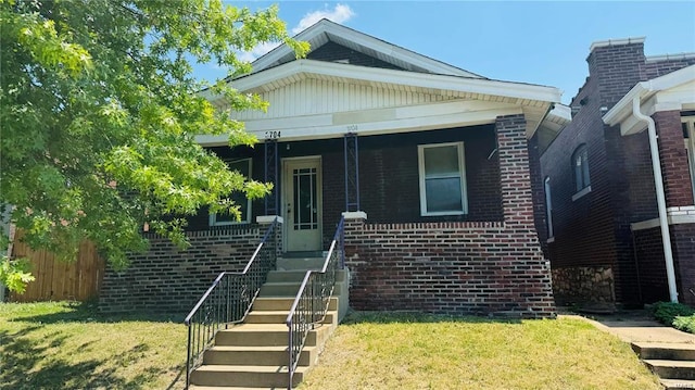 bungalow-style house featuring a front lawn