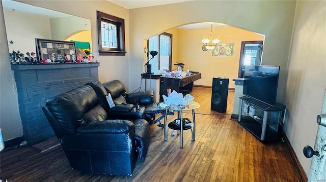 living room with wood-type flooring and a chandelier