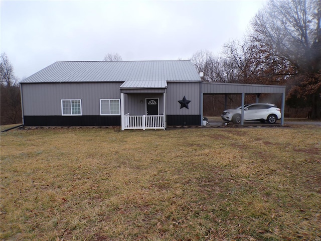 view of outbuilding featuring a porch, a yard, and a carport