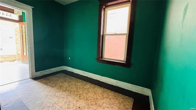 spare room with tile patterned floors