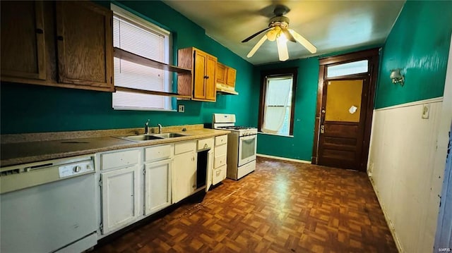 kitchen with sink, white appliances, ceiling fan, dark parquet flooring, and white cabinets