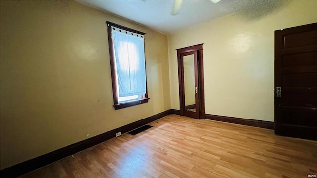 unfurnished room with ceiling fan and light hardwood / wood-style floors