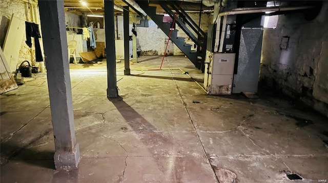 basement featuring heating unit and washing machine and clothes dryer