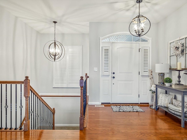 foyer with hardwood / wood-style flooring and a chandelier