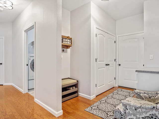 foyer entrance featuring washer / clothes dryer and light hardwood / wood-style flooring