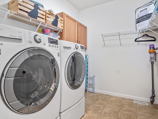 washroom with independent washer and dryer and cabinets