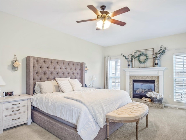 carpeted bedroom with ceiling fan and multiple windows