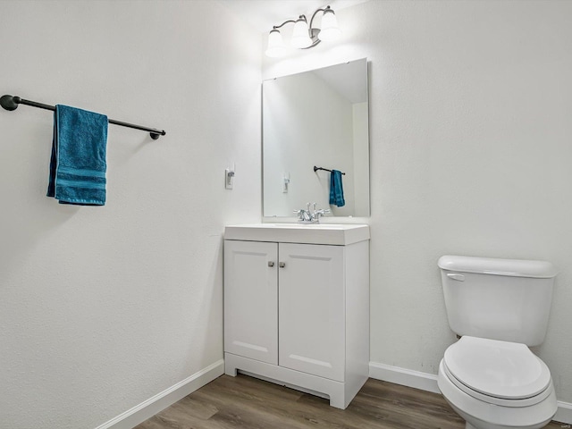 bathroom featuring hardwood / wood-style flooring, vanity, and toilet