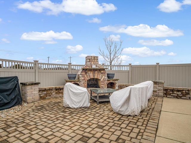 view of patio featuring grilling area and an outdoor stone fireplace