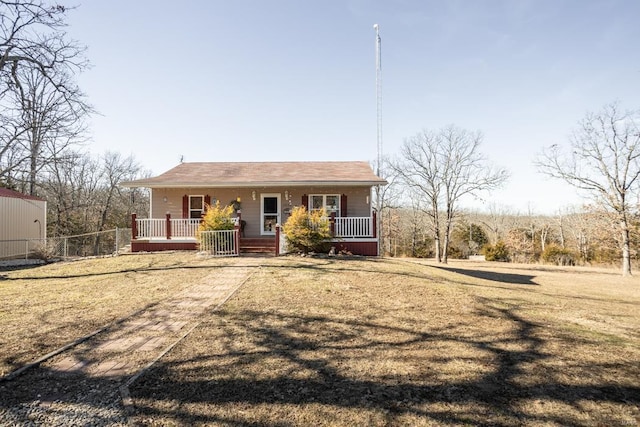 view of front facade with covered porch and a front lawn