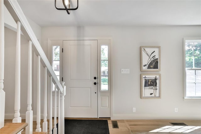 entryway with wood-type flooring