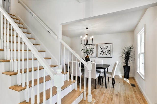 dining area featuring a notable chandelier and light hardwood / wood-style flooring