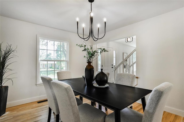 dining room with a notable chandelier and light hardwood / wood-style floors