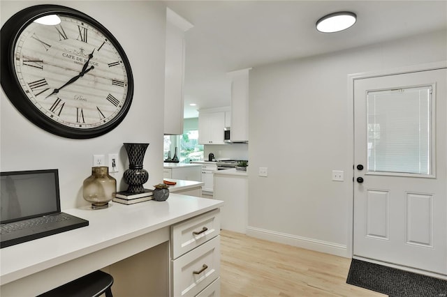 foyer featuring built in desk and light hardwood / wood-style flooring