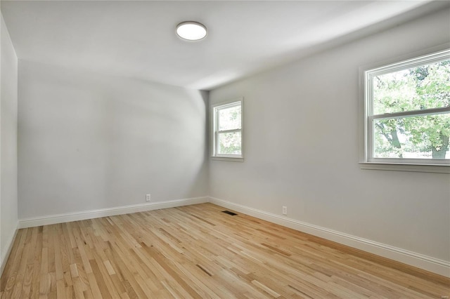 unfurnished room with light wood-type flooring