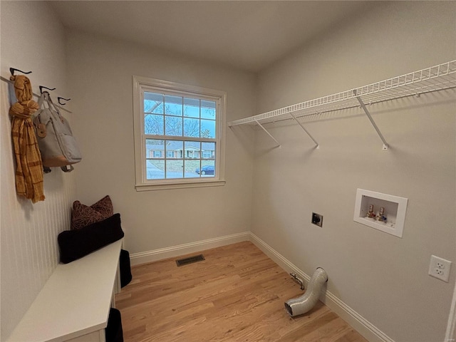 washroom with hardwood / wood-style floors, hookup for a washing machine, and hookup for an electric dryer