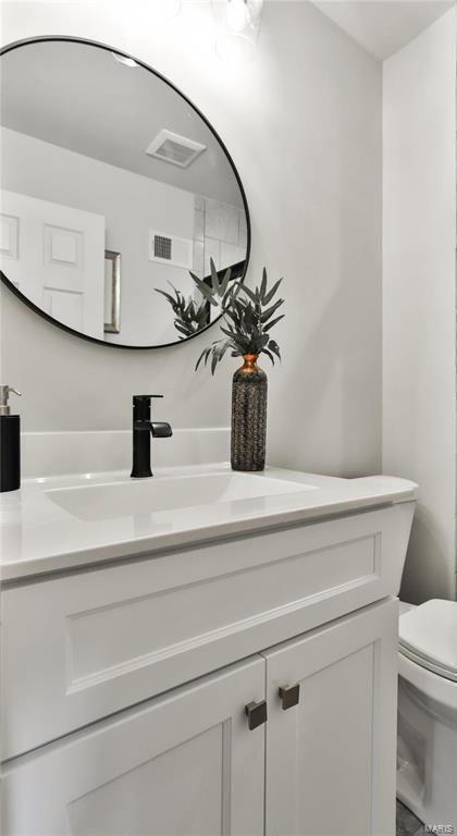 bathroom featuring vanity and toilet