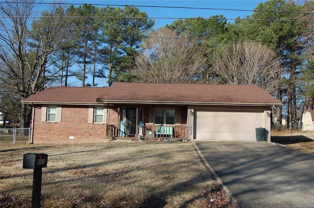 view of front of house with a porch, a garage, and a front lawn