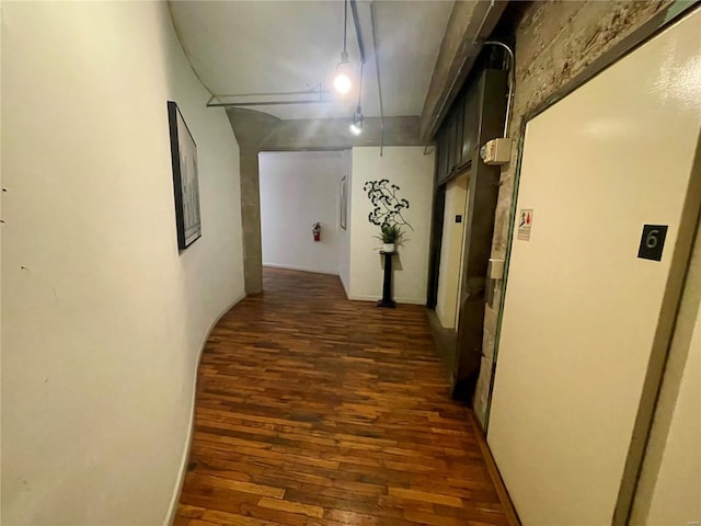 corridor featuring dark hardwood / wood-style flooring