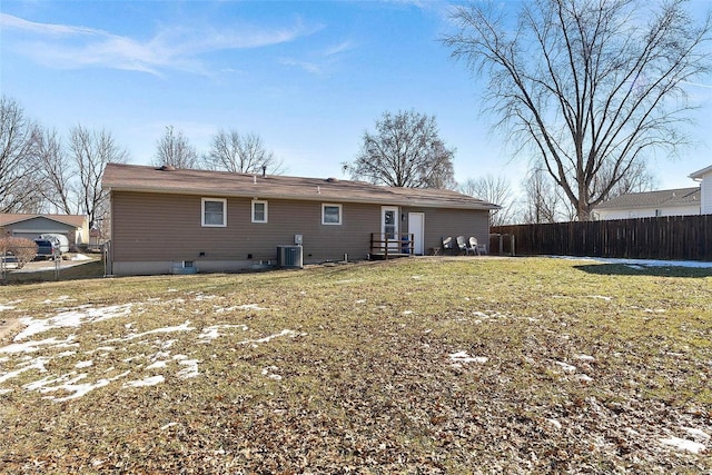 back of house featuring a yard and central air condition unit