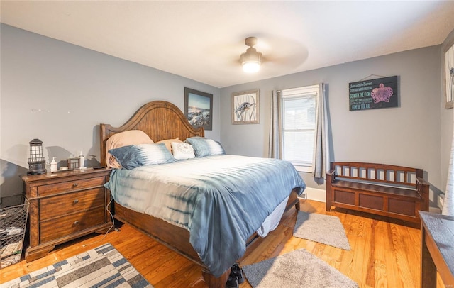 bedroom with ceiling fan and hardwood / wood-style floors