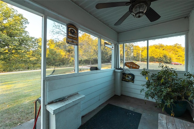 unfurnished sunroom with ceiling fan