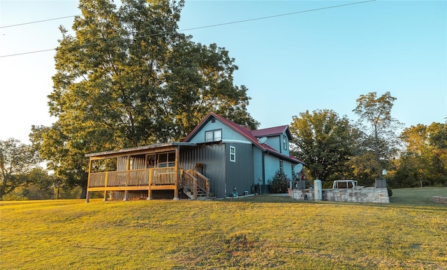 exterior space featuring a wooden deck and a front lawn