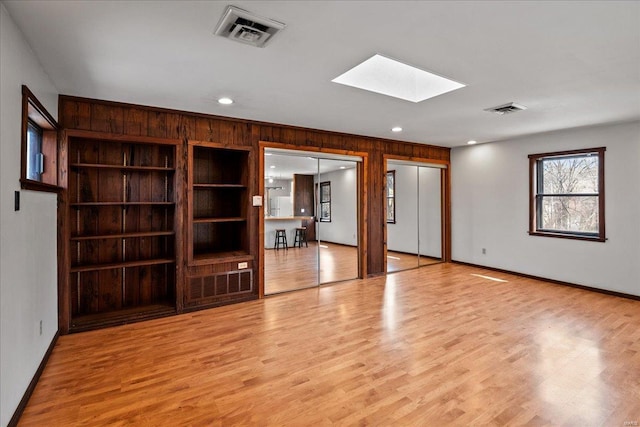 interior space featuring a skylight, recessed lighting, visible vents, and light wood-type flooring