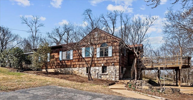 view of home's exterior with a wooden deck and stairway