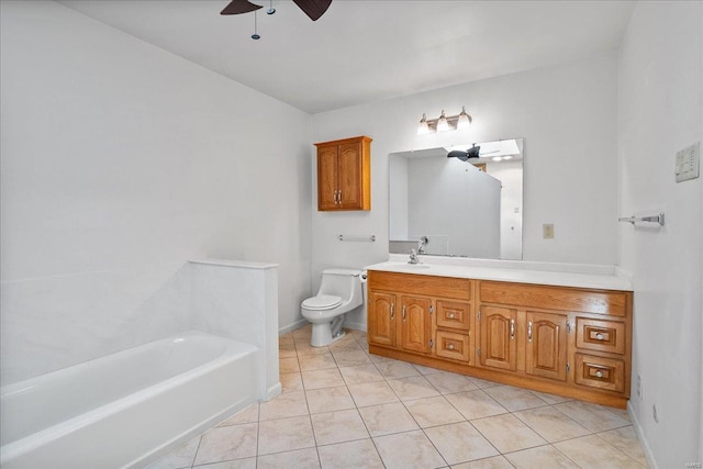 bathroom with toilet, a tub to relax in, a ceiling fan, tile patterned flooring, and vanity