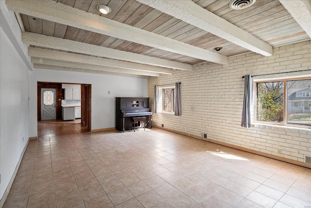 unfurnished living room with tile patterned flooring, wooden ceiling, beamed ceiling, and brick wall