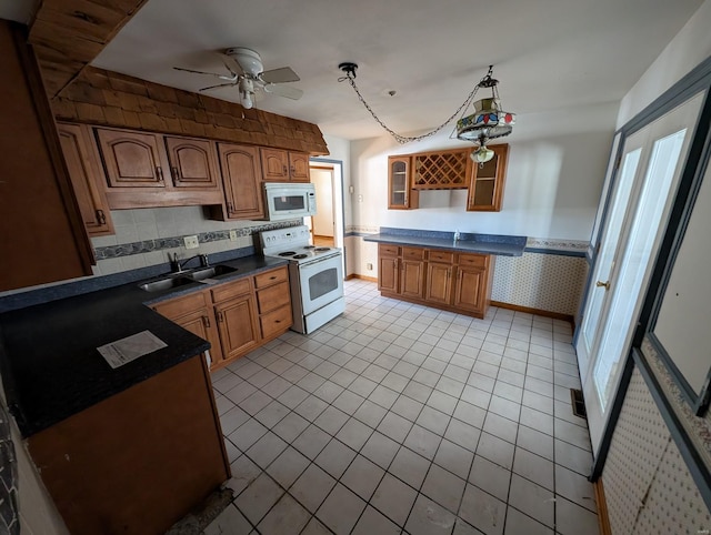 kitchen featuring sink, light tile patterned floors, ceiling fan, pendant lighting, and white appliances