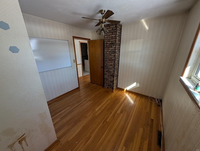 empty room with ceiling fan and wood-type flooring