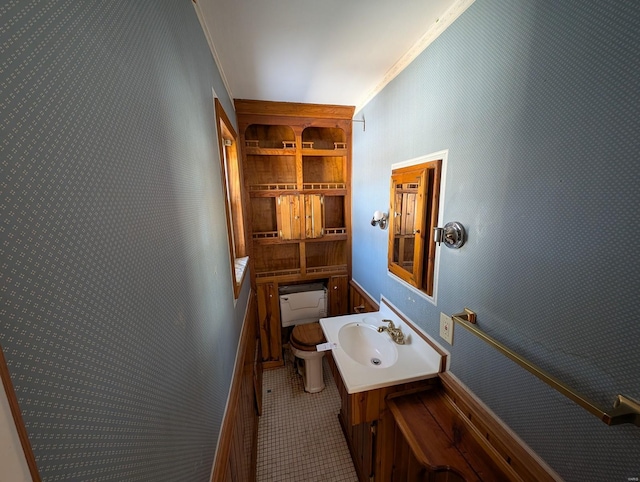 bathroom with vanity, ornamental molding, and toilet