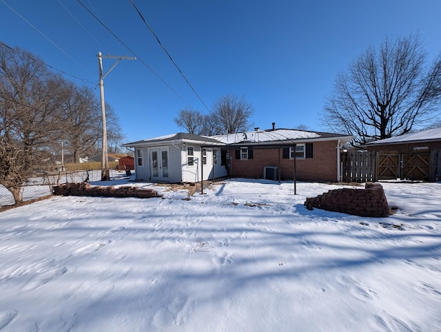 view of snow covered rear of property