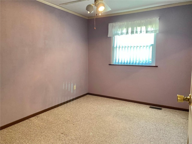 carpeted empty room featuring crown molding and ceiling fan