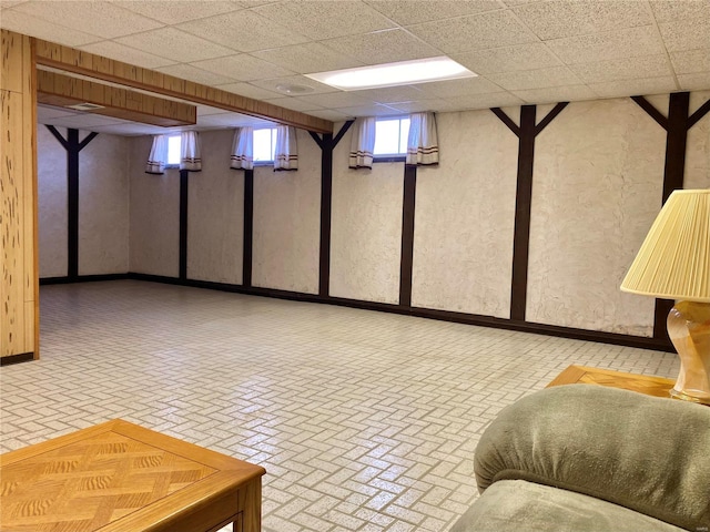 basement featuring a paneled ceiling