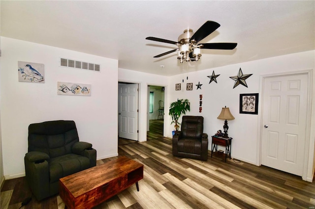 sitting room with ceiling fan and dark hardwood / wood-style flooring