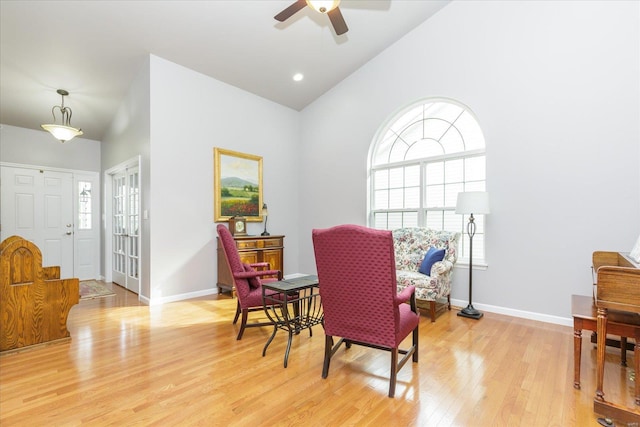 sitting room with high vaulted ceiling, light hardwood / wood-style floors, and ceiling fan